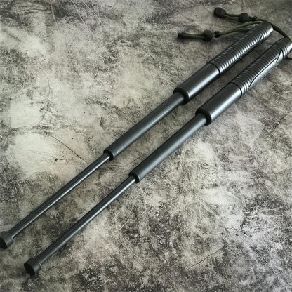 Two batons fully extended on concrete showing the three-section shafts