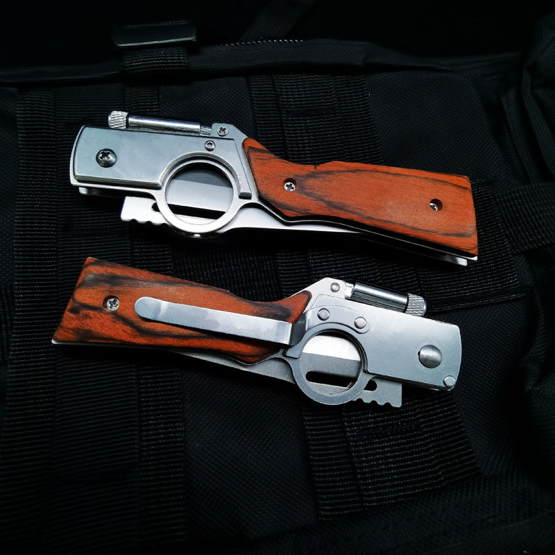 Two closed wood-handle folding knives showing pocket clip and finger-hole frame on black fabric