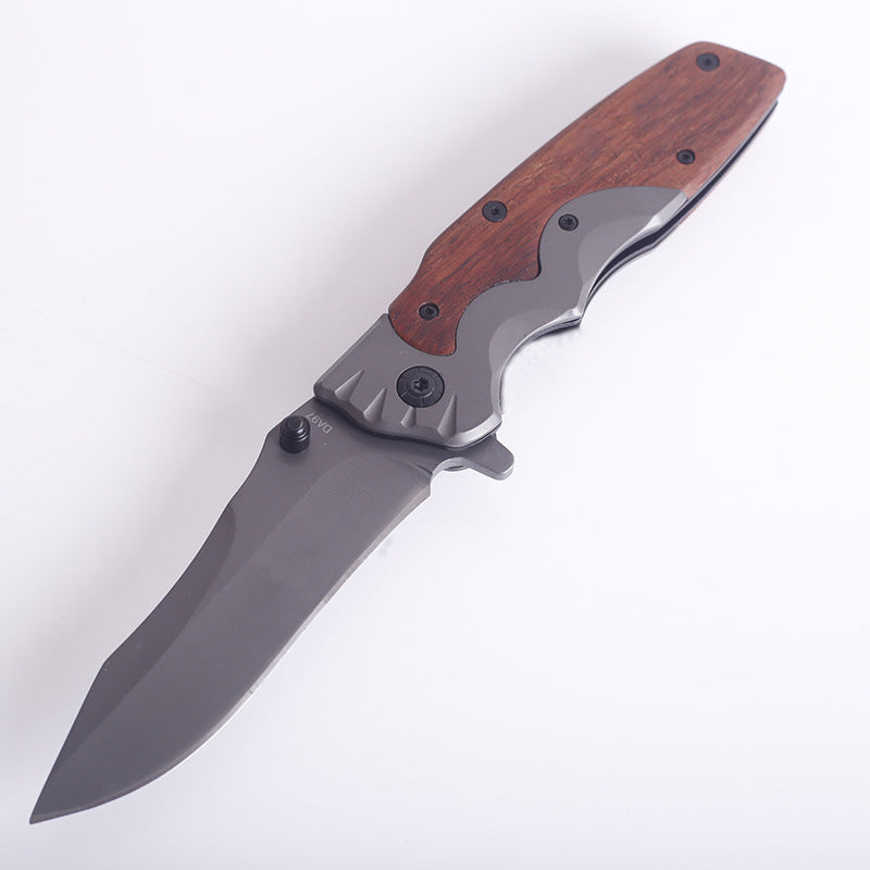 Wood-handle folding knife open on a white surface, reddish-brown scales and gray blade in view