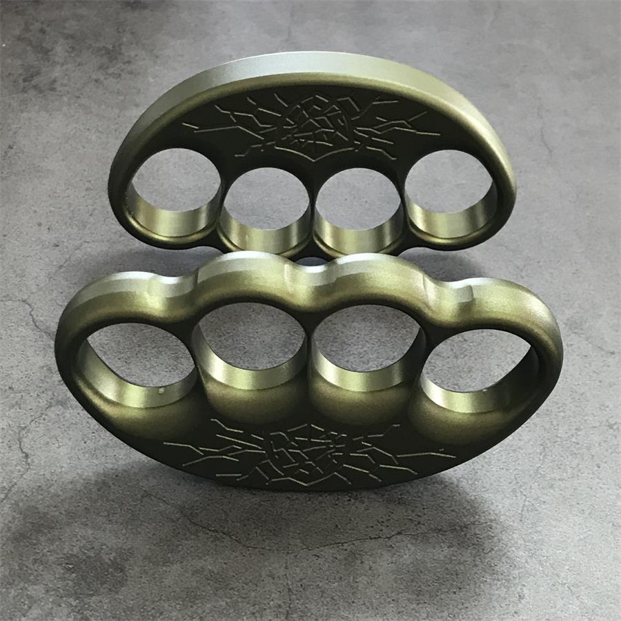 Knuckle duster worn across gloved fingers in closed hold