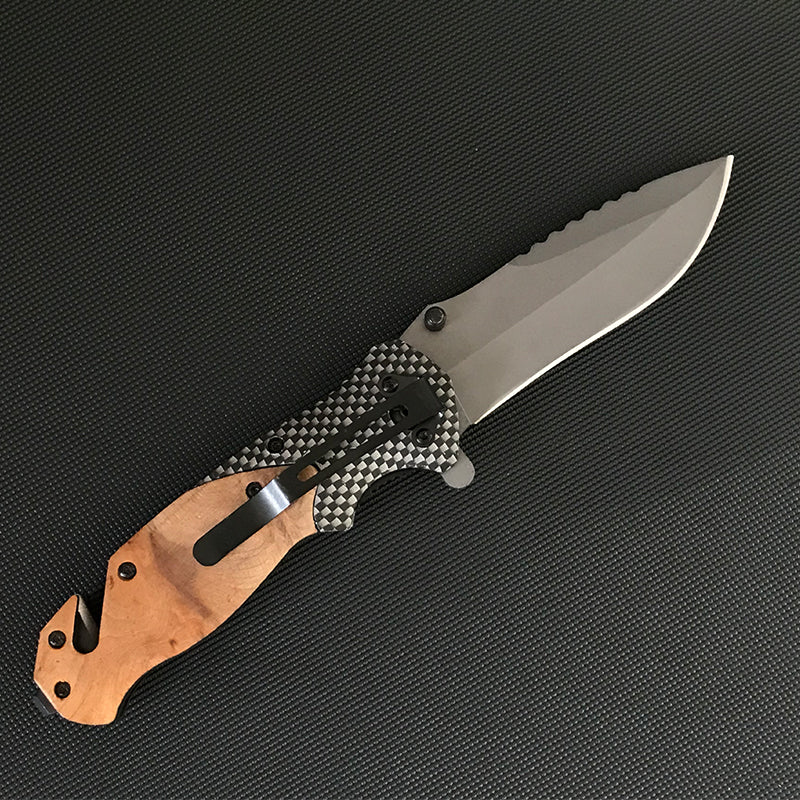 Back view of the open Liome X50 showing carbon fiber pattern scales, black pocket clip, wood front and rear scales and the sawback spine
