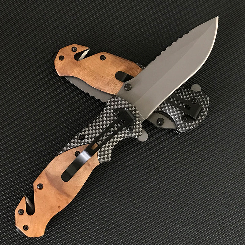 Two Liome X50 knives crossed showing the carbon fiber pattern back scales and black pocket clip beside the wooden front